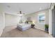 Bright, spacious main bedroom featuring large windows with a scenic lake view and neutral decor at 5059 Bromeliad Ave, Wimauma, FL 33598