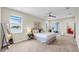 Bright main bedroom featuring neutral tones, lake view, ceiling fan, and access to a screened patio at 5059 Bromeliad Ave, Wimauma, FL 33598
