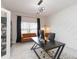 Bright office space with modern decor, stylish light fixture, large desk, and decorative accent wall at 5059 Bromeliad Ave, Wimauma, FL 33598