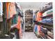 Organized walk-in closet features shelving and hanging racks for clothing, shoes, and accessories at 5059 Bromeliad Ave, Wimauma, FL 33598