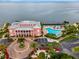 Aerial view of property featuring a pool, pier, lush landscaping and waterfront at 5102 Coquina Key Se Dr # D, St Petersburg, FL 33705