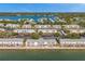 Aerial view of waterfront condos with balconies overlooking the bay and nearby marina at 5102 Coquina Key Se Dr # D, St Petersburg, FL 33705