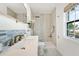 Updated bathroom has a tub and shower with a glass enclosure, and a window at 5102 Coquina Key Se Dr # D, St Petersburg, FL 33705
