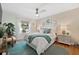 Airy bedroom featuring coastal-inspired decor, a ceiling fan, and a view to the outdoors at 5102 Coquina Key Se Dr # D, St Petersburg, FL 33705