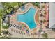 A large community pool with lounge chairs and tables at 5102 Coquina Key Se Dr # D, St Petersburg, FL 33705