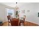 Cozy dining room with stylish light fixture and seating for four at 5102 Coquina Key Se Dr # D, St Petersburg, FL 33705