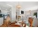 Dining space with a view of the living room and kitchen, featuring a round table with seating at 5102 Coquina Key Se Dr # D, St Petersburg, FL 33705