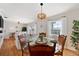 Bright dining area featuring a round glass table with seating for four and an open view to the living room at 5102 Coquina Key Se Dr # D, St Petersburg, FL 33705