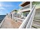 Exterior view of a row of beach side villas with stairs and balconies at 5102 Coquina Key Se Dr # D, St Petersburg, FL 33705
