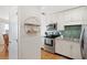 Updated kitchen with white cabinets, stainless steel appliances, and an open doorway to the dining area at 5102 Coquina Key Se Dr # D, St Petersburg, FL 33705