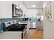 Well-lit kitchen boasting stainless steel appliances, white cabinetry, and a stylish tile backsplash at 5102 Coquina Key Se Dr # D, St Petersburg, FL 33705