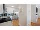 Bright kitchen showcasing white cabinets, stainless steel appliances, and a decorative wall piece at 5102 Coquina Key Se Dr # D, St Petersburg, FL 33705