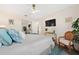 Bright bedroom has a mirrored closet, ceiling fan, decor, and a television at 5102 Coquina Key Se Dr # D, St Petersburg, FL 33705