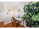 Bright office space with hardwood floors, a stylish desk, and a decorative plant for a comfortable and productive work environment at 5102 Coquina Key Se Dr # D, St Petersburg, FL 33705
