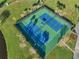 Aerial view of the community tennis courts in lush, green surroundings at 5102 Coquina Key Se Dr # D, St Petersburg, FL 33705