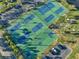 Aerial view of community tennis and basketball courts with parking at 5102 Coquina Key Se Dr # D, St Petersburg, FL 33705