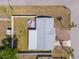 Aerial view of the home featuring a private backyard deck, gray roof, and spacious surroundings at 5117 Fitchburg Dr, Holiday, FL 34690
