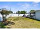 Expansive backyard features lush grass, a white fence, and inviting outdoor space at 5117 Fitchburg Dr, Holiday, FL 34690