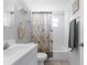 Bathroom featuring a sink, bathtub with shower, and towel racks at 5117 Fitchburg Dr, Holiday, FL 34690