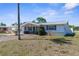 Charming single-story home with manicured lawn and gray roof, perfect for a cozy lifestyle at 5117 Fitchburg Dr, Holiday, FL 34690