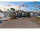 Charming single-story home with a well-maintained gravel front yard and inviting exterior lighting at 5117 Fitchburg Dr, Holiday, FL 34690