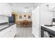 Bright kitchen with white cabinets, appliances, and a view of the dining area at 5117 Fitchburg Dr, Holiday, FL 34690