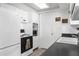 Functional kitchen space featuring white appliances, ample storage, and a view to dining area at 5117 Fitchburg Dr, Holiday, FL 34690