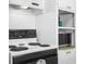 Close up on the kitchen stove with white countertops and white cabinetry and microwave at 5117 Fitchburg Dr, Holiday, FL 34690
