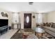 Inviting living room featuring comfortable seating, a patterned rug, and a front door at 5117 Fitchburg Dr, Holiday, FL 34690
