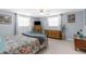 Main bedroom featuring neutral carpet, a bed, multiple windows, and dressers at 5117 Fitchburg Dr, Holiday, FL 34690