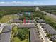 Expansive aerial view of townhomes with lake views and lush greenery in a desirable neighborhood at 6225 Scarlet Darter Way, Tampa, FL 33625