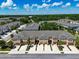 Aerial view of the townhomes with attached garages and well maintained landscaping at 6225 Scarlet Darter Way, Tampa, FL 33625
