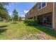 Exterior view of backyard with lush green lawn and screened patio at 6225 Scarlet Darter Way, Tampa, FL 33625