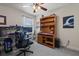 Bedroom with a desk featuring dual monitors and wood bookcase with a sports motif at 6225 Scarlet Darter Way, Tampa, FL 33625