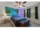 Comfortable bedroom with a world map tapestry and two windows with black curtains for natural light at 6225 Scarlet Darter Way, Tampa, FL 33625