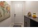 The entryway has a world map, decorative accents on a cabinet, and a white front door with modern hardware at 6225 Scarlet Darter Way, Tampa, FL 33625