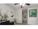 Hallway with a ceiling fan, a plant, and a framed painting, providing access to multiple rooms at 6225 Scarlet Darter Way, Tampa, FL 33625