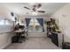 Comfortable home office with a large desk, dual monitors, and natural light from the two windows at 6225 Scarlet Darter Way, Tampa, FL 33625