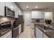 Modern kitchen equipped with stainless steel appliances, granite counters, and ample cabinet space at 6225 Scarlet Darter Way, Tampa, FL 33625