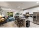 Open-concept kitchen and living area with modern appliances, granite countertops, and backyard access at 6225 Scarlet Darter Way, Tampa, FL 33625