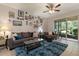Comfortable living room featuring a plush sofa, glass coffee table, and a sliding glass door to the patio at 6225 Scarlet Darter Way, Tampa, FL 33625