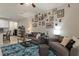 Living room with ample artwork on the wall, a ceiling fan, and a plush blue rug at 6225 Scarlet Darter Way, Tampa, FL 33625