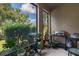 Screened patio with potted plants and outdoor grill at 6225 Scarlet Darter Way, Tampa, FL 33625