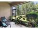 Screened patio with lush green backyard views, potted plants and patio furniture at 6225 Scarlet Darter Way, Tampa, FL 33625