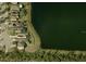 Aerial view showcasing lakefront homes with private pools and solar panels in a serene neighborhood at 711 Parker Den Dr, Ruskin, FL 33570