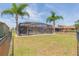 Large backyard featuring a screened-in pool and a neatly fenced yard at 711 Parker Den Dr, Ruskin, FL 33570