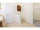 This bathroom features tile floors, a toilet, built-in cabinet and door to closet at 711 Parker Den Dr, Ruskin, FL 33570