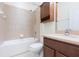 This bathroom features a shower/tub combo, vanity and storage cabinet at 711 Parker Den Dr, Ruskin, FL 33570