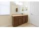 This bathroom features a wood vanity, large mirror and tile floors at 711 Parker Den Dr, Ruskin, FL 33570