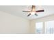 Bedroom with a ceiling fan and large windows overlooking the backyard at 711 Parker Den Dr, Ruskin, FL 33570
